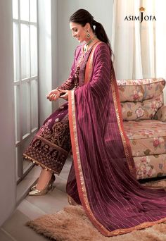 FABRIC: VELVET COLOR: MAGENTA PRODUCT DETAILS Ruby: Ayeza Khan beams dressed in this beautiful attire. Magenta velvet shirt comprised of a center and side panels dusted with glinting sequins harmoniously used with burnt orange, olive green and pale pink thread interlaced with golden zari ending in heavy borders. It comes with linear embroidered chiffon dupatta and dyed silk pants.DESIGN DETAILS:1 Center Panel on Velvet for Front2 Side Panels on Velvet for Front(W=30”) Embroidered Back on VelvetP Magenta Velvet, Pakistani Boutique, Asim Jofa, Pink Thread, Ayeza Khan, Color Magenta, Embroidered Chiffon, Velvet Shirt, Velvet Collection