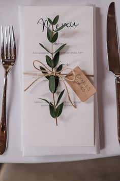 a place setting with silverware, forks and napkins on top of a table