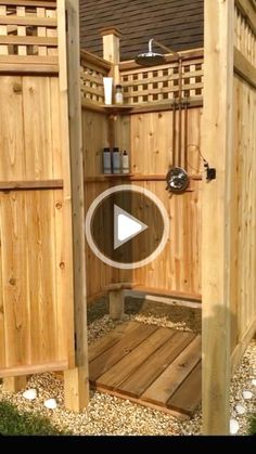 a wooden shower in the middle of a yard