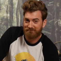 a man with a beard is making a funny face