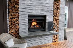 a fireplace with firewood stacked on top of it