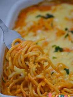 a close up of a fork in a casserole dish