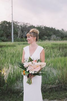 a woman in a white dress holding a bouquet