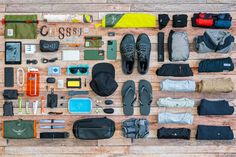 the contents of a backpack laid out on a wooden floor next to it's contents