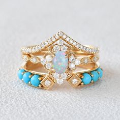 Felicegals Oval Opal & Turquoise Vintage Gold Ring Set 3pcs Opal Engagement Rings Antique Moissanite Turquoise Wedding Band Vintage Inspired Ring Art Deco Bridal Anniversary Gift Promise Ring 14k solid gold band Lab Opal, 4*6mm, about 0.5ct Turquoise Accents Colourless Moissanite Accents The moissanite accents version features VS to VVS clarity. 0.35ct total carat weight 1.6mm bandwidth ** This item is specially made for you. Turquoise Wedding Ring Set, Turquoise Engagement Rings, Turquoise Wedding Ring, Turquoise Diamond Rings, Turquoise Wedding Rings, Fire Opal Engagement Ring, Turquoise Wedding Band, Vintage Gold Ring, Turquoise Ring Engagement