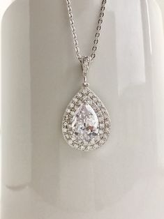 Beautiful! clear cubic zirconia bridal tear drop pendant and necklace in rhodium plated brass setting. Necklace pendant features a large teardrop with pear cut cubic zirconia center surrounded by two rows of tiny zirconia crystals which dangles from a cubic zirconia detailed bail. Length of the rhodium plated chain is 18 inches and comes with 2 inches extender and lobster clasp. For matching earrings click: https://www.etsy.com/listing/495791548/teardrop-crystal-earrings-bridal-cubic?ref=listing Tear Drop Pendant, Crystal Wedding Jewelry, Wedding Bridesmaid Jewelry, Jewelry Bridesmaid, Necklace Wedding, Teardrop Pendant, Crystal Wedding, Bridal Necklace, Drop Pendant