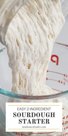 a hand mixing sourdough in a glass bowl with the words easy 2 - ingredient sourdough starter