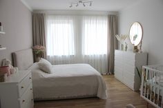 a baby's room with a bed, dresser and crib