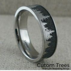 this wedding ring is made from silver and has trees on the inside, with black inlays