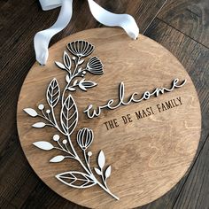 a wooden sign that says welcome to the de mast family with leaves and branches on it