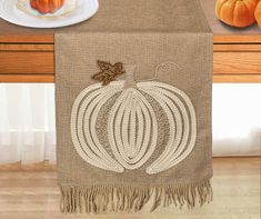 a table runner with a pumpkin on it