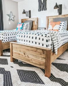 two wooden beds sitting next to each other on top of a white carpeted floor