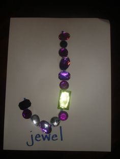 a necklace made out of glass beads and stones with the name jewel written on it