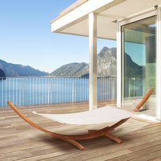 a white hammock sitting on top of a wooden deck