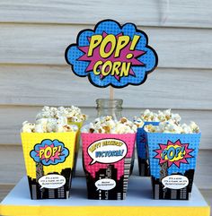 pop corn cupcakes with popcorn in them on a table