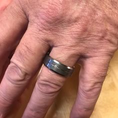 an older man's hand with a ring on it, showing the middle finger