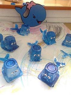 there are many blue items on the table with eyes and nose shapes painted on them