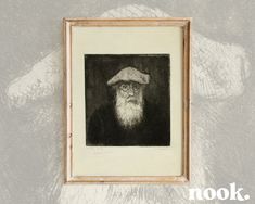 an old man with a hat and beard is framed in a wooden frame on the wall