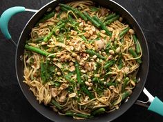 a pan filled with pasta and green beans