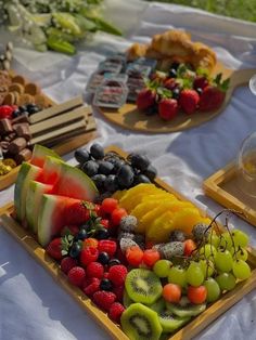 there are many different fruits on the trays that are ready to be served at this party