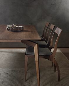 a wooden table with two chairs next to it