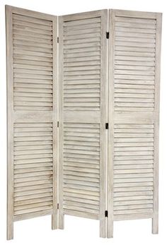 a white room divider with shutters on the top and bottom panel, in front of a white background