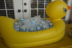 an inflatable ducky filled with bottled water sits on top of a table