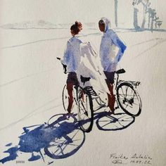 two people are riding bicycles on the street