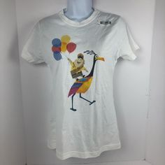 a white t - shirt with an image of a bird holding balloons