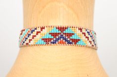 Introducing our adjustable southwestern beaded cuff bracelets! This colorful cuff bracelet is handmade with a southwestern-inspired pattern in cream, dark red, blue, orange, turquoise, and soft yellow.The bracelet is strung on strong beading thread and flexible leather cord with an adjustable closure, making it easy to put on and take off, while also allowing you to customize your fit. It will fit 6-8 inch wrists.Whether you're dressing up for a special occasion or just accenting your everyday s Beading Thread, Orange Turquoise, Beaded Cuff Bracelet, Beaded Cuff, Soft Yellow, Blue Bracelet, Natural Leather, Leather Cord, Dark Red