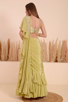 Green lehenga saree with ruffled pallu and hand embroidered moti blossom detailing. Paired with a sleeveless brocade bloom jaal detail blouse using moti, sequins, beads highlights. - Aza Fashions Fitted Pista Green Pre-draped Saree For Eid, Fitted Georgette Sets With Dori Work, Diwali Dress With Unstitched Blouse In Pista Green, Pista Green Pre-draped Saree With Dori Work For Wedding, Diwali Pista Green Dress With Unstitched Blouse, Fitted Pre-draped Saree With Dori Work For Diwali, Fitted Art Silk Pre-draped Saree For Wedding, Pista Green Georgette Gown With Traditional Drape, Fitted Saree-shaped Gown With Cutdana