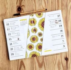 a calendar with sunflowers on it next to a pencil