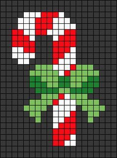 a cross stitch christmas ornament in red, white and green on a black background