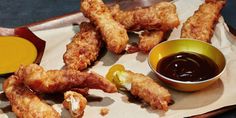 some fried food on a tray with dipping sauce