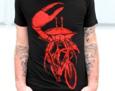 Dark Cycle Clothing Custom Screen Printed Mens Black T-shirt The underwater emissions were becoming of concern for sea predators so when the shark decided to stop fussing and start a revolution he was soon followed by a deluge of whales, octopi, and now crabs. This Dark Cycle exclusive is screen printed with the bright red discharge ink on a super soft standard black 100% cotton t-shirt. Printing with discharge is a process that dyes the shirt, rather than laying ink on top, so after the first w Crab Shirt, Riding A Bicycle, Dachshund Shirt, Tshirt Custom, Custom Screen Printing, Bike Shirts, Cycling Outfit, Unisex Shirts, American Apparel