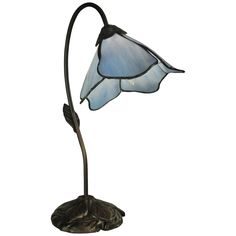 a lamp that is on top of a metal stand with a glass shade over it