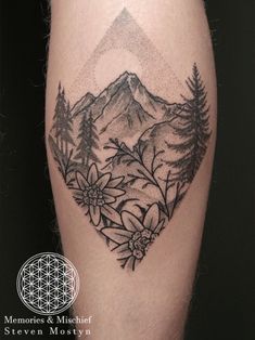 a black and white photo of a mountain with flowers on it's side thigh