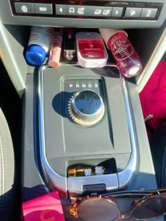 an electronic device with sunglasses and other items on it's display shelf in the passenger seat