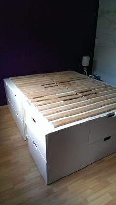 a bed with two drawers on each side