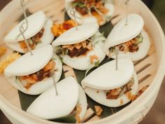 some food is sitting in a bowl with toothpicks sticking out of it's sides