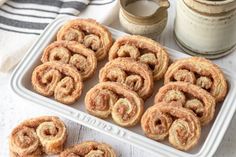 several cinnamon rolls on a white tray