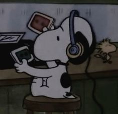 a cartoon dog sitting on top of a stool holding a cell phone and headphones