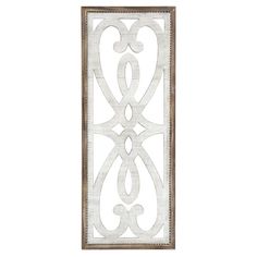 a decorative metal wall hanging on the side of a white wall with an intricate design