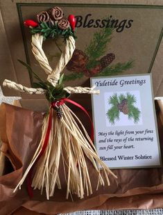 an ornament made out of twine with pine cones and red berries on it