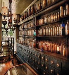 an old fashioned pharmacy cabinet with lots of medicine bottles on the shelves in front of it