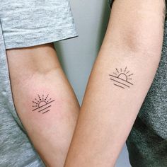 two people with matching tattoos on their arms, one has a sun and the other has a cactus