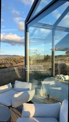 there is a large glass window on the outside of this house with white furniture in front of it