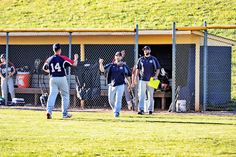 some baseball players are walking on the field