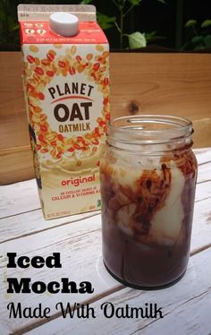 iced mocha made with oatmeal in a jar next to a carton of oats milk