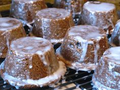 there are many cakes that have frosting on top of each other, and one is sitting on a cooling rack